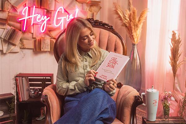 Anne Wilson holding her devotional Hey Girl